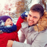 Father-and-young-son-playing-outside-in-the-snow
