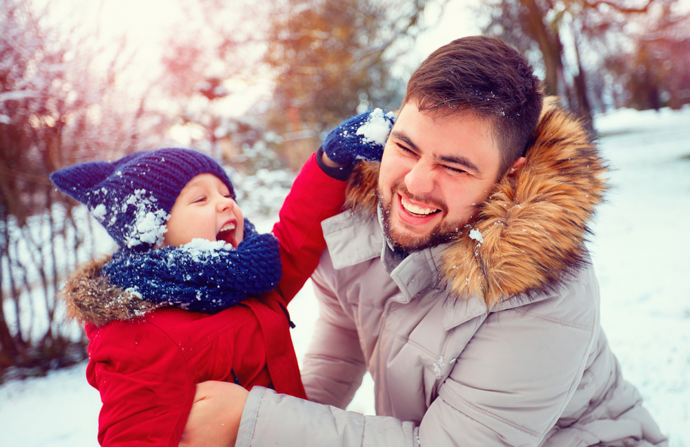Father-and-young-son-playing-outside-in-the-snow