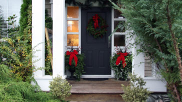 Front-porch-beautifully-decorated-with-evergreen-wreath-and-planters
