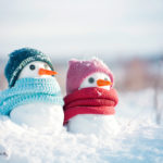 Two-miniature-snowmen-wearing-a-hat-and-scarf.