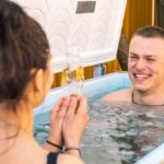 Young-couple-bathing-in-cold-water-tub-with-ice-floating-around-them