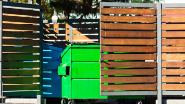 Dumpsters-hidden-behind-wooden-slatted-garbage-can-enclosures.