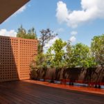Private-outdoor-balcony-lined-with-plants-and-privacy-wall.